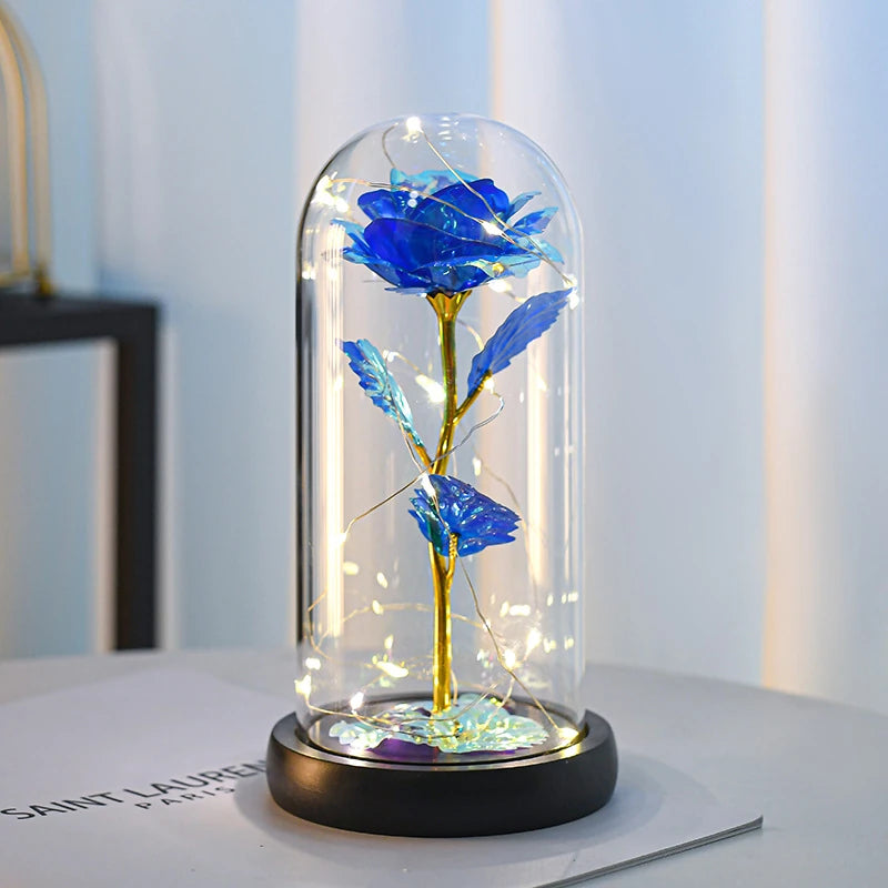 Forever Rose in blue, lit under its clear dome
