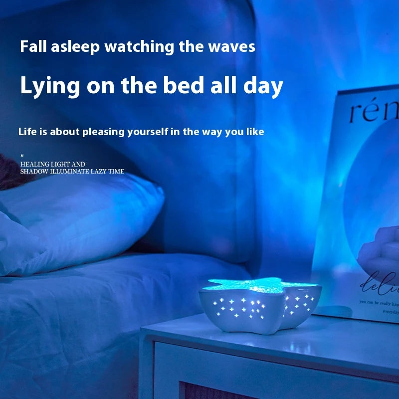 Starfish Lume on a nightstand filling a bedroom with blue ocean ripples