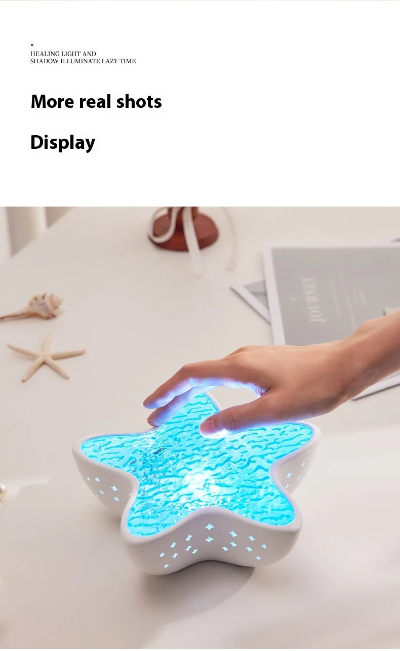 A hand touching the lit Starfish Lume