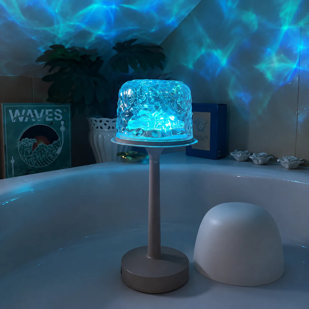 Tide Lume lit in blue, spreading water ripples across the wall behind it